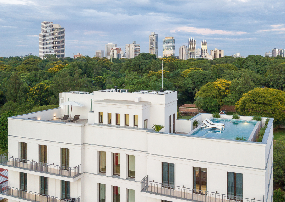 a bird's eye view image of an apartment building with a skyline in the background